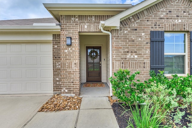 13919 Leigh Lake Ln, Conroe, TX 77384 - property entrance featuring brick siding, a garage, and driveway