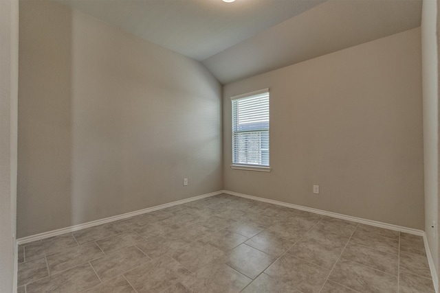 13919 Leigh Lake Ln, Conroe, TX 77384 - spare room featuring vaulted ceiling and light tile patterned floors