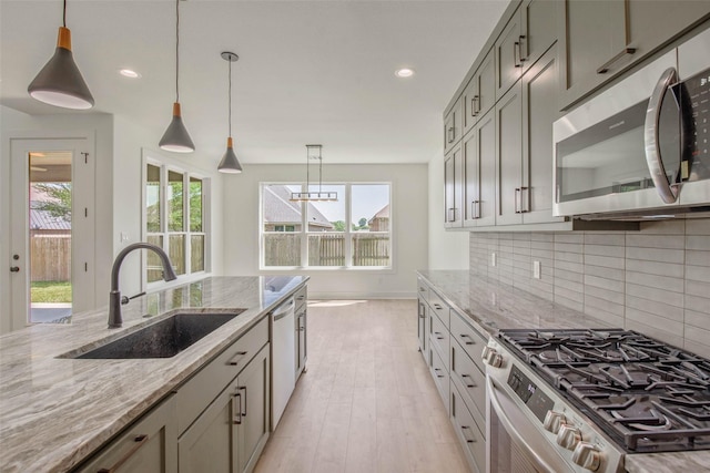 3034 Teller Dr, Bryan, TX 77808 - kitchen with stainless steel appliances, a sink, plenty of natural light, tasteful backsplash, and recessed lighting