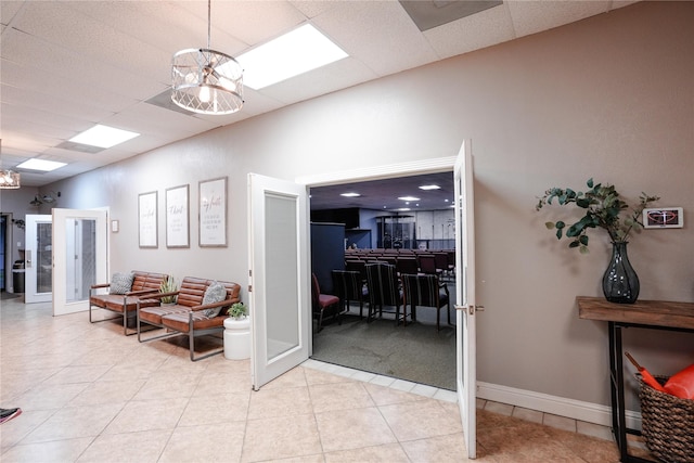 2027 Fm 1942nd Rd, Crosby, TX 77532 - hall featuring french doors, light tile patterned flooring, a chandelier, and a drop ceiling