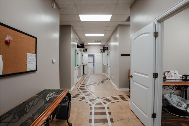 2027 Fm 1942nd Rd, Crosby, TX 77532 - corridor featuring a drop ceiling, inlaid floor details, and baseboards
