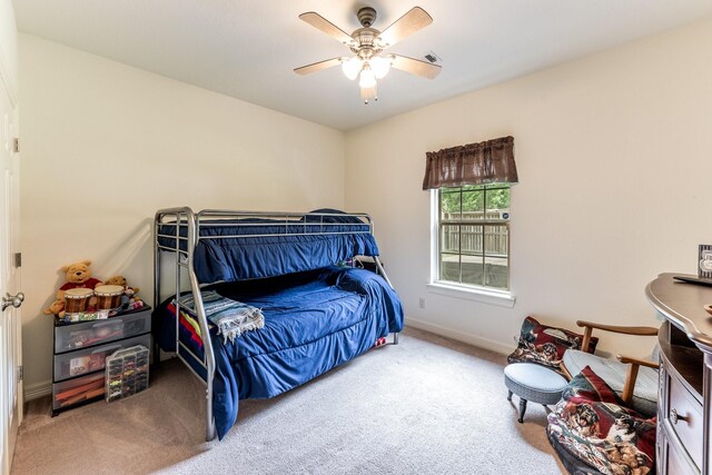 2312 W Green Briar Dr, Huntsville, TX 77340 - bedroom with carpet, baseboards, and ceiling fan