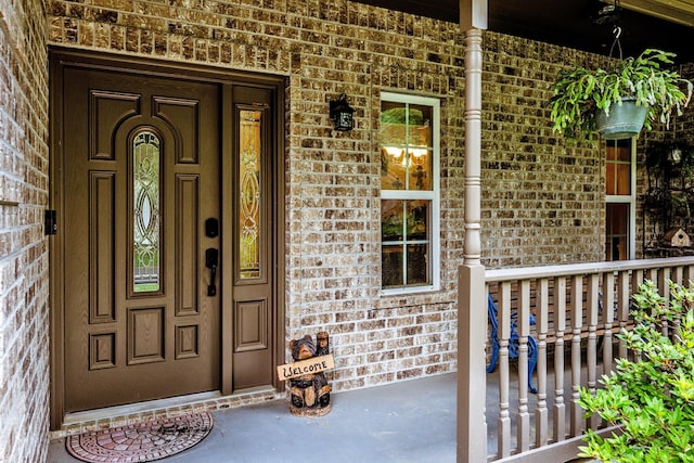 2312 W Green Briar Dr, Huntsville, TX 77340 - doorway to property featuring covered porch and brick siding