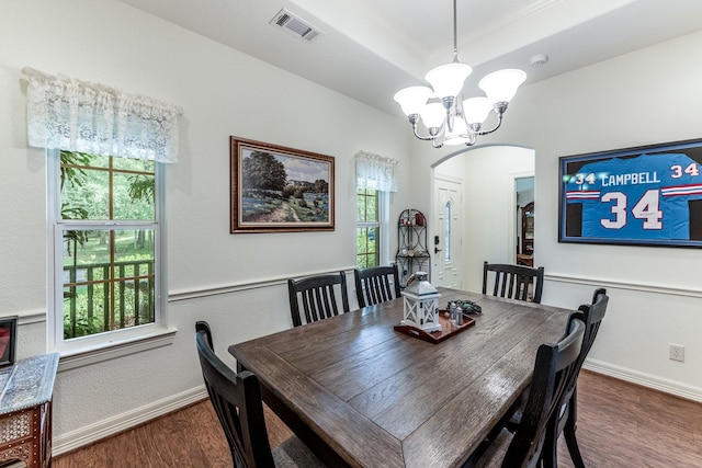 2312 W Green Briar Dr, Huntsville, TX 77340 - dining room with arched walkways, a chandelier, wood finished floors, and baseboards