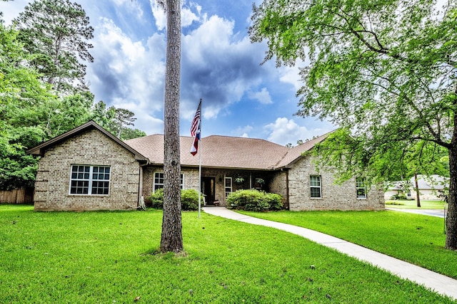 2312 W Green Briar Dr, Huntsville, TX 77340 - ranch-style home featuring brick siding, a front yard, and roof with shingles