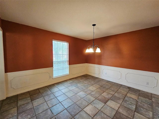 16438 Glenshannon Dr, Houston, TX 77059 - unfurnished room with wainscoting and a chandelier