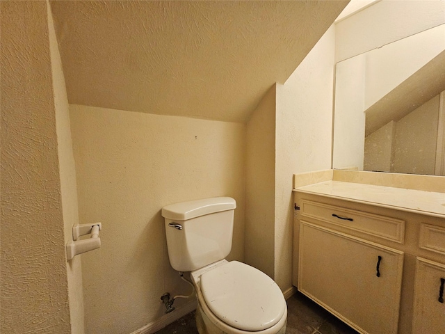 16438 Glenshannon Dr, Houston, TX 77059 - bathroom with vanity, toilet, lofted ceiling, a textured ceiling, and a textured wall