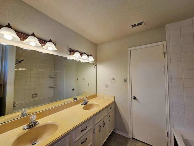 16438 Glenshannon Dr, Houston, TX 77059 - bathroom featuring double vanity, a textured ceiling, and bathtub / shower combination