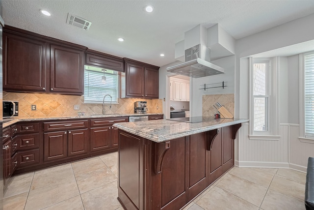 16418 Crawford St, Jersey Village, TX 77040 - kitchen featuring plenty of natural light, light stone counters, appliances with stainless steel finishes, light tile patterned flooring, and wainscoting