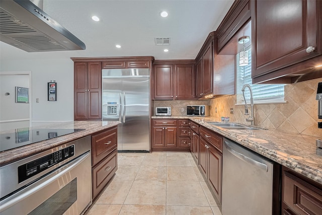 16418 Crawford St, Jersey Village, TX 77040 - kitchen featuring appliances with stainless steel finishes, ventilation hood, light stone counters, decorative backsplash, and recessed lighting