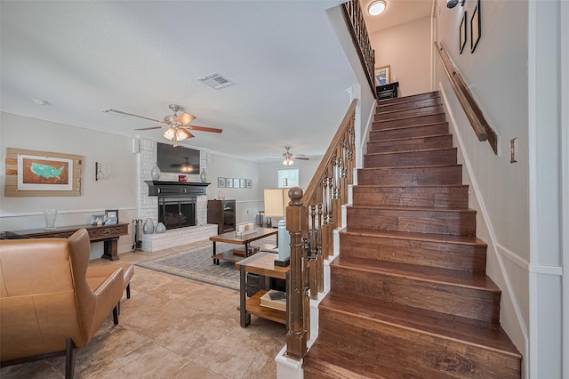 16418 Crawford St, Jersey Village, TX 77040 - staircase with a ceiling fan, a fireplace, crown molding, and tile patterned flooring