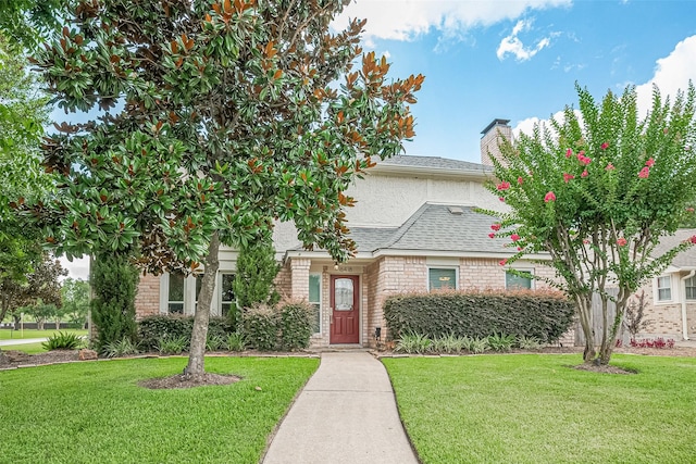16418 Crawford St, Jersey Village, TX 77040 - view of front of house with a front lawn, a chimney, and roof with shingles