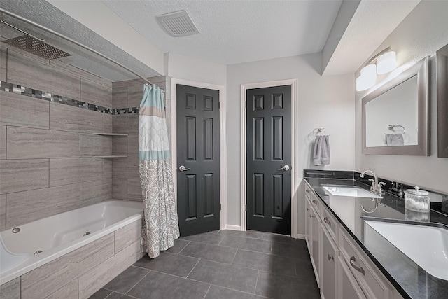 16418 Crawford St, Jersey Village, TX 77040 - bathroom featuring tile patterned flooring, double vanity, tiled shower / bath, and a textured ceiling