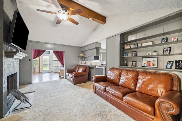 1105 Mesquite St, Baytown, TX 77521 - living area featuring a brick fireplace, a ceiling fan, and a textured ceiling