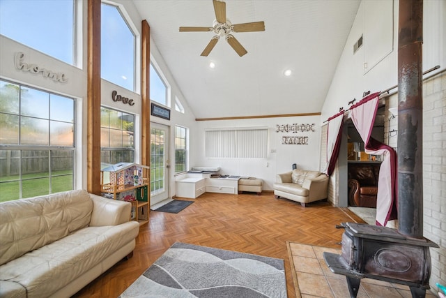 1105 Mesquite St, Baytown, TX 77521 - living room featuring a ceiling fan, high vaulted ceiling, and a wood stove