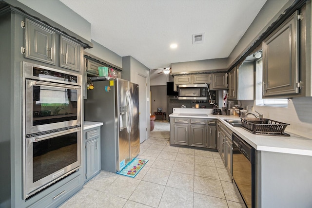 1105 Mesquite St, Baytown, TX 77521 - kitchen with appliances with stainless steel finishes, light countertops, tasteful backsplash, light tile patterned floors, and a ceiling fan