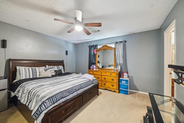 1105 Mesquite St, Baytown, TX 77521 - bedroom featuring light carpet, a textured ceiling, and a ceiling fan