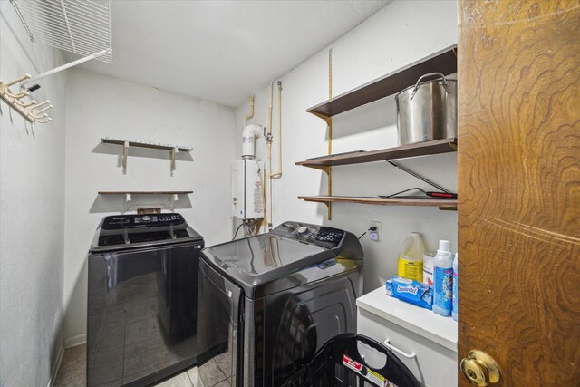 1105 Mesquite St, Baytown, TX 77521 - laundry room with washer and clothes dryer and water heater