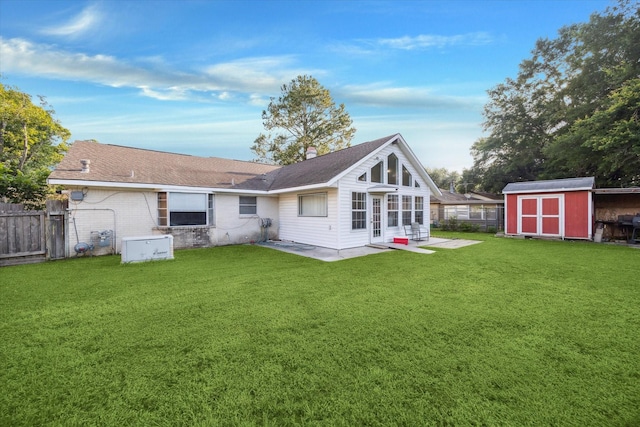 1105 Mesquite St, Baytown, TX 77521 - rear view of property with a shed, a patio area, a chimney, brick siding, and a shingled roof