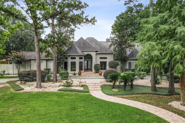 51 Wincrest Falls Dr, Cypress, TX 77429 - view of front of house featuring french doors, a front yard, stucco siding, and a shingled roof