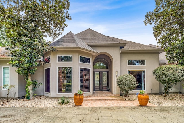 51 Wincrest Falls Dr, Cypress, TX 77429 - view of front of home with french doors, roof with shingles, and stucco siding