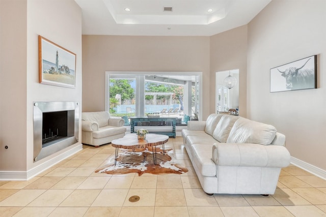 51 Wincrest Falls Dr, Cypress, TX 77429 - living area with a high ceiling, light tile patterned floors, a raised ceiling, and recessed lighting