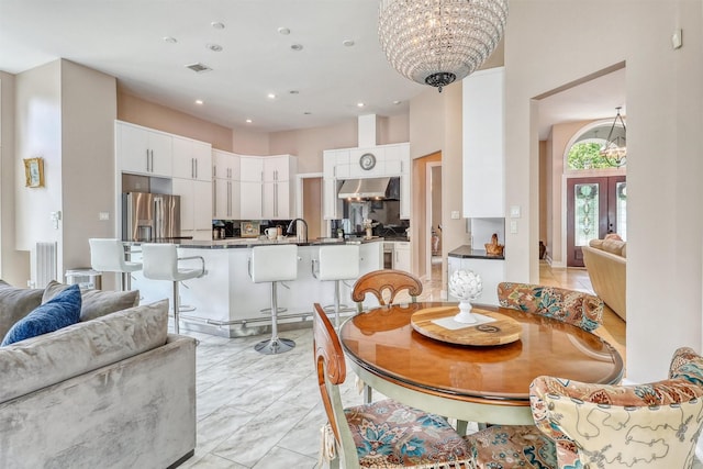 51 Wincrest Falls Dr, Cypress, TX 77429 - dining room with a chandelier, french doors, recessed lighting, and light marble finish floors