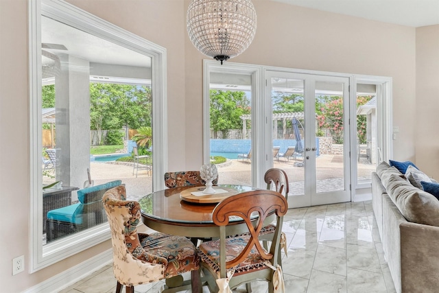 51 Wincrest Falls Dr, Cypress, TX 77429 - dining room featuring light marble finish floors, french doors, and a chandelier