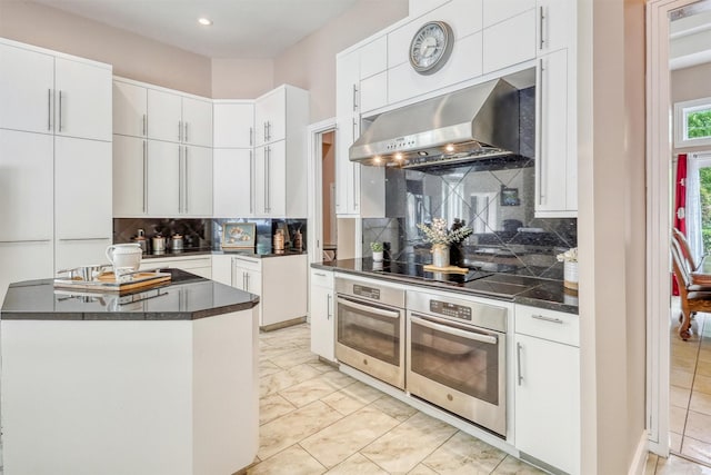 51 Wincrest Falls Dr, Cypress, TX 77429 - kitchen featuring oven, exhaust hood, white cabinetry, and recessed lighting