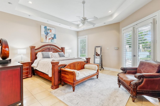 51 Wincrest Falls Dr, Cypress, TX 77429 - bedroom featuring a tray ceiling, access to exterior, light tile patterned floors, recessed lighting, and a ceiling fan