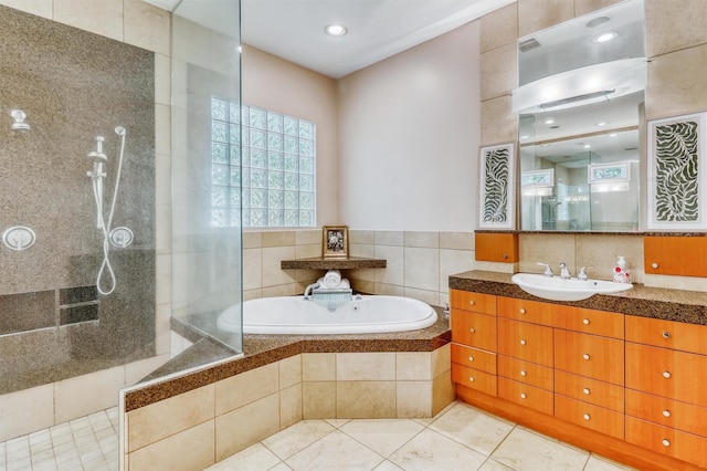 51 Wincrest Falls Dr, Cypress, TX 77429 - bathroom with walk in shower, vanity, a bath, tile patterned flooring, and recessed lighting