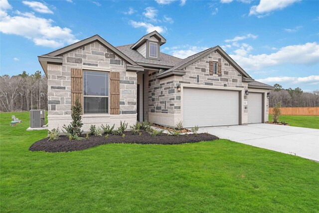 520 Barton Place Dr, Cleveland, TX 77327 - view of front of property with stone siding, concrete driveway, an attached garage, and a front yard