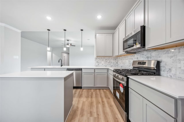520 Barton Place Dr, Cleveland, TX 77327 - kitchen with stainless steel appliances, a peninsula, backsplash, a sink, and ceiling fan