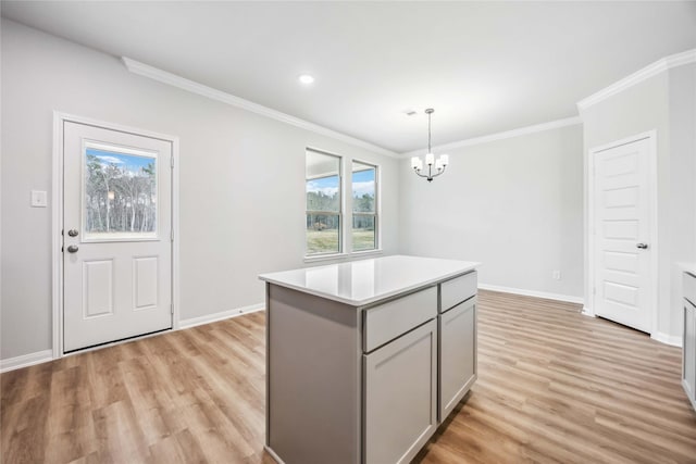 520 Barton Place Dr, Cleveland, TX 77327 - kitchen with gray cabinets, a chandelier, light wood-style flooring, light countertops, and ornamental molding