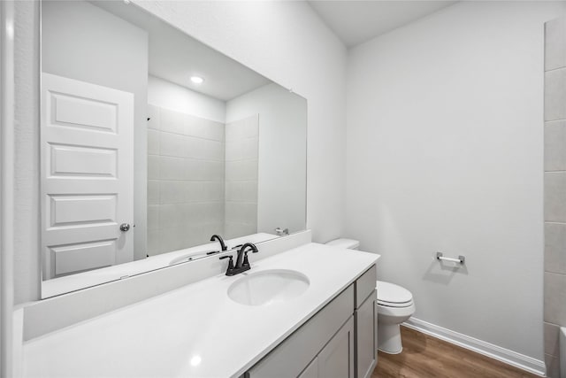 520 Barton Place Dr, Cleveland, TX 77327 - full bathroom featuring toilet, wood finished floors, vanity, baseboards, and recessed lighting