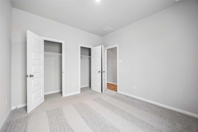 520 Barton Place Dr, Cleveland, TX 77327 - unfurnished bedroom featuring two closets, carpet flooring, and baseboards