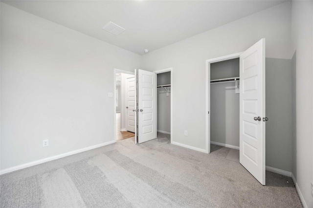520 Barton Place Dr, Cleveland, TX 77327 - unfurnished bedroom with two closets, carpet flooring, and baseboards