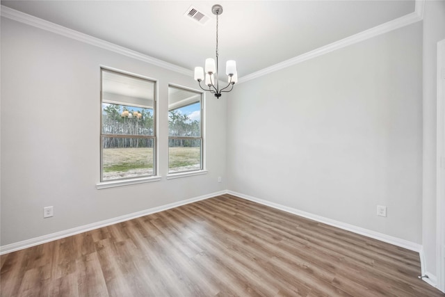 520 Barton Place Dr, Cleveland, TX 77327 - empty room featuring a chandelier, ornamental molding, wood finished floors, and baseboards