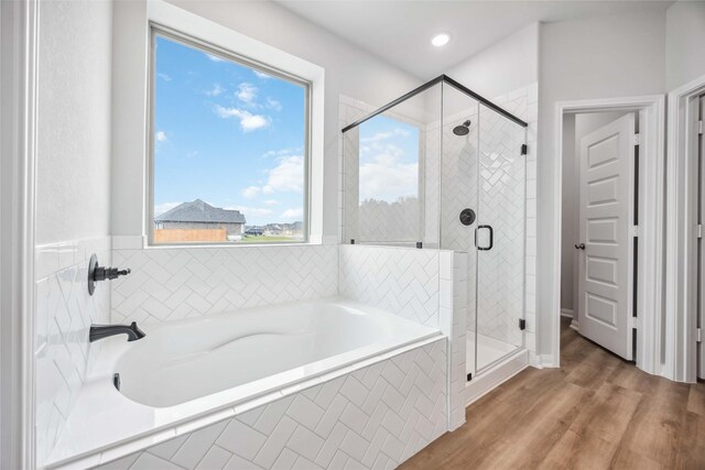 520 Barton Place Dr, Cleveland, TX 77327 - bathroom with a garden tub, a shower stall, and wood finished floors