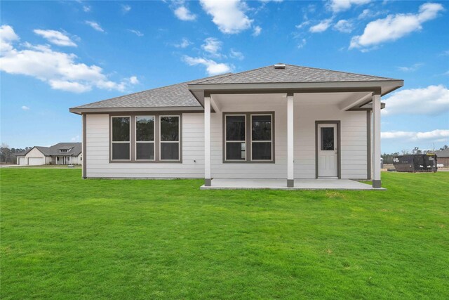 520 Barton Place Dr, Cleveland, TX 77327 - rear view of property featuring a patio area, a lawn, and roof with shingles
