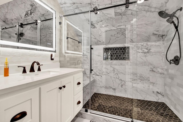 22827 Edward Ln, Tomball, TX 77377 - bathroom featuring a marble finish shower, vanity, and tasteful backsplash