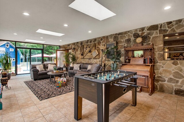 22827 Edward Ln, Tomball, TX 77377 - playroom with a skylight, expansive windows, tile patterned flooring, and recessed lighting
