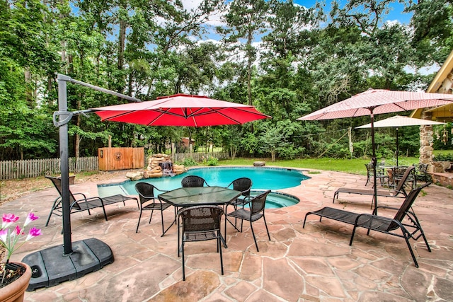 22827 Edward Ln, Tomball, TX 77377 - view of swimming pool featuring a fenced backyard, view of scattered trees, a patio area, and a jacuzzi
