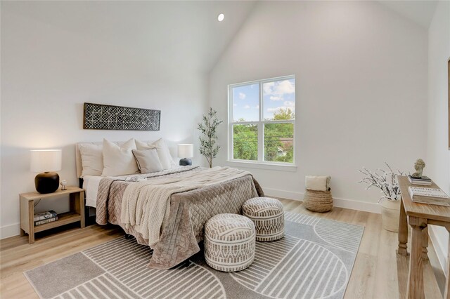 311 Marcella St Unit A, Houston, TX 77091 - bedroom featuring high vaulted ceiling, baseboards, light wood finished floors, and recessed lighting