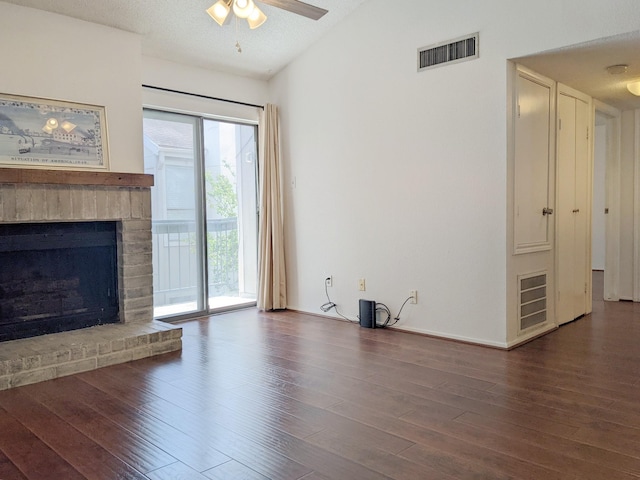 7950 N Stadium Dr Unit 136, Houston, TX 77030 - unfurnished living room with vaulted ceiling, wood finished floors, a ceiling fan, and a fireplace