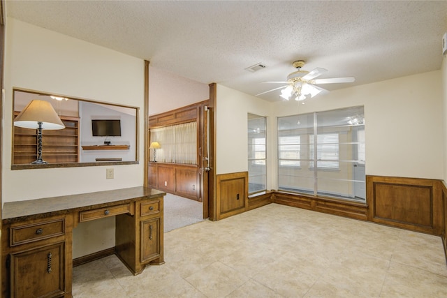 55 Flag Ct, Lake Jackson, TX 77566 - unfurnished office featuring a textured ceiling, ceiling fan, and a wainscoted wall