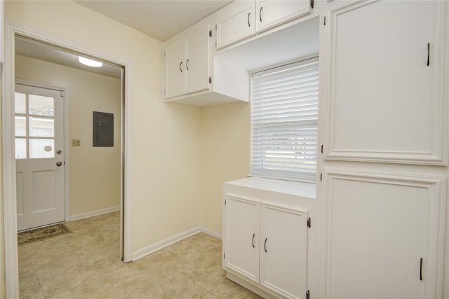 55 Flag Ct, Lake Jackson, TX 77566 - washroom featuring electric panel, baseboards, and light tile patterned flooring