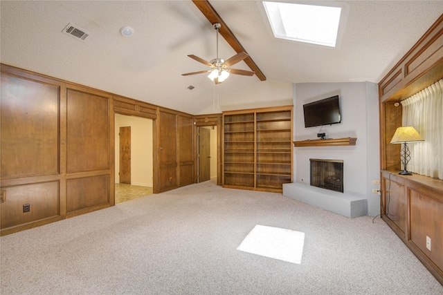 55 Flag Ct, Lake Jackson, TX 77566 - unfurnished living room with a fireplace with raised hearth, light colored carpet, and a ceiling fan