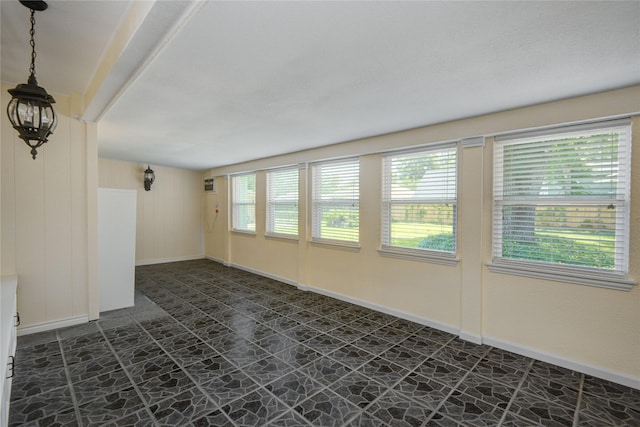 55 Flag Ct, Lake Jackson, TX 77566 - unfurnished room featuring stone floors, baseboards, and a wall unit AC
