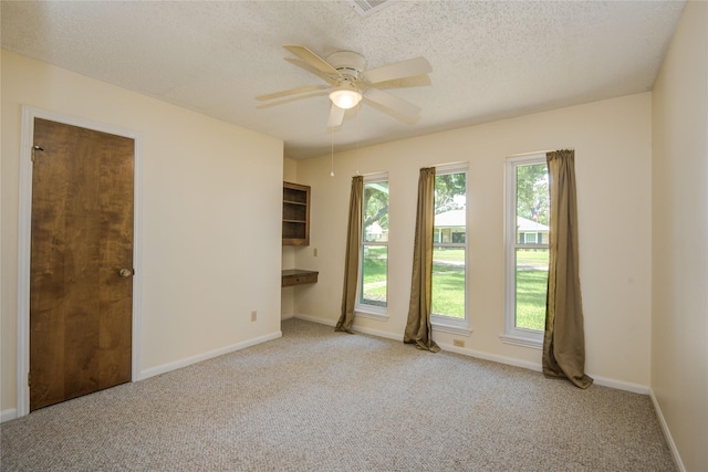 55 Flag Ct, Lake Jackson, TX 77566 - spare room featuring light colored carpet, a textured ceiling, a ceiling fan, and baseboards